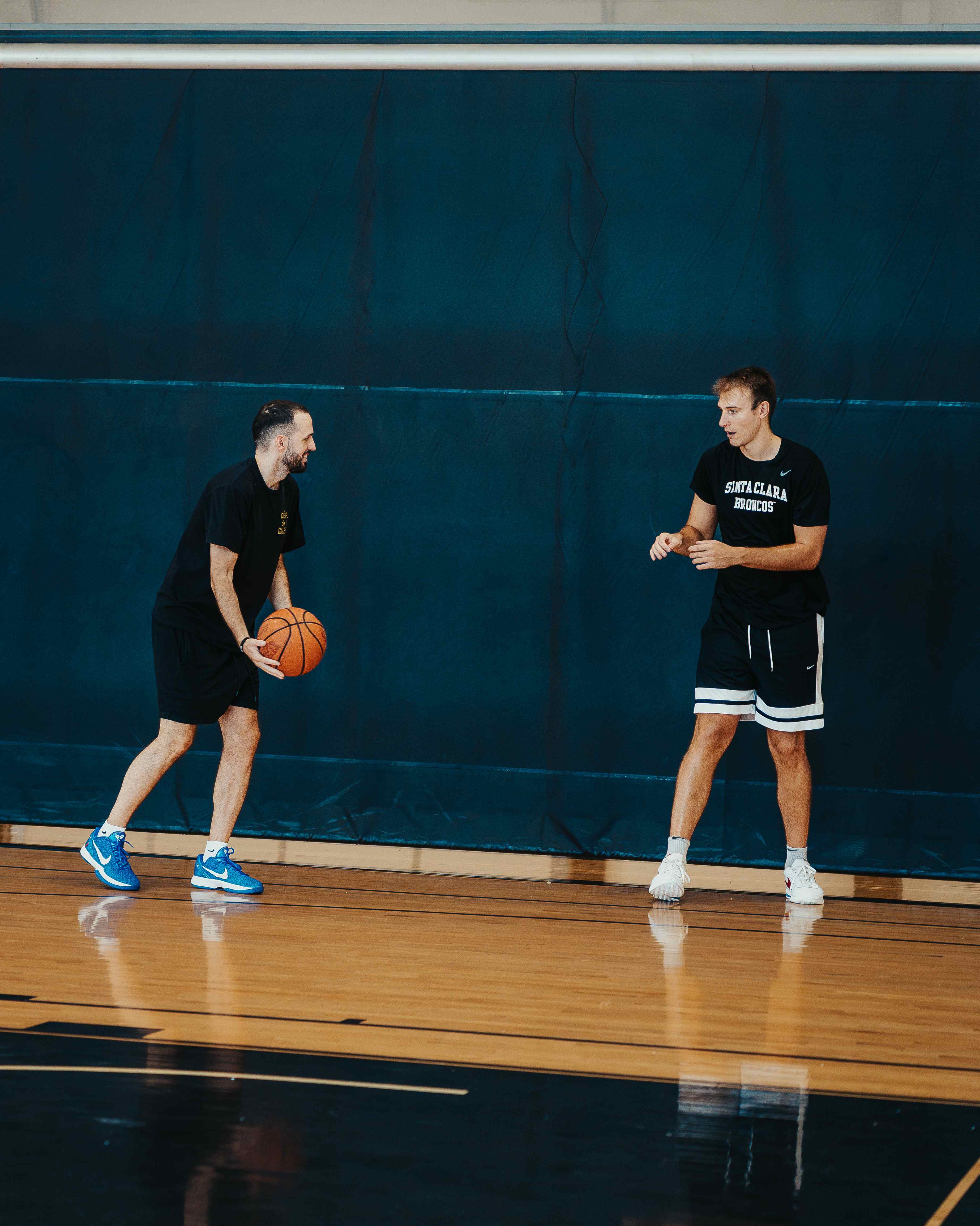 Coach and player sharing a laugh during a passing drill