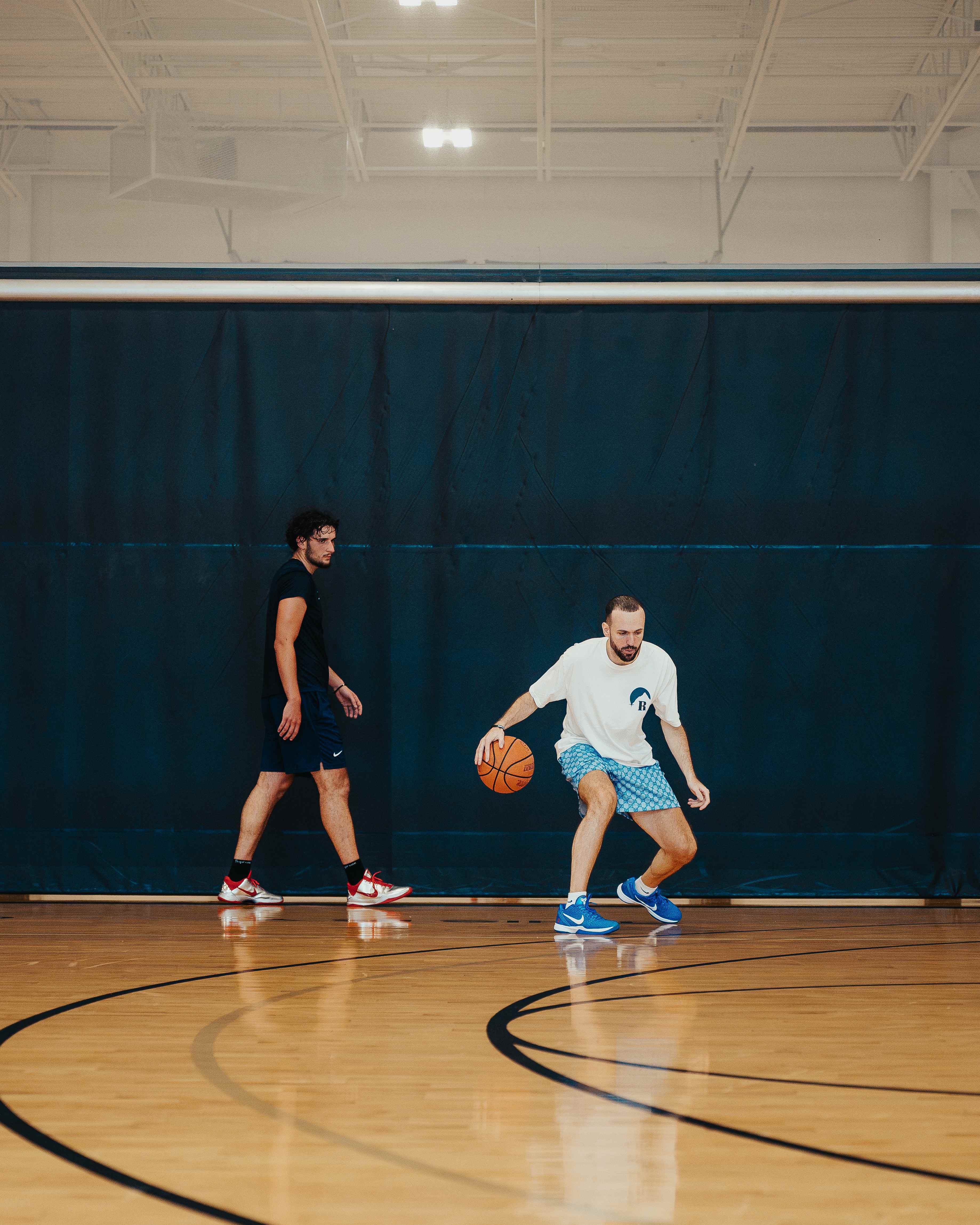 Coach working on low dribble moves on the court